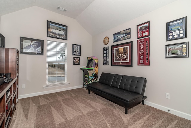 living area featuring vaulted ceiling and carpet