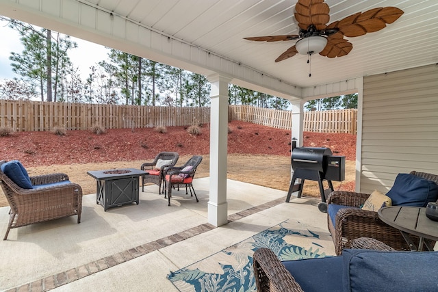 view of patio / terrace with area for grilling, a fire pit, and ceiling fan