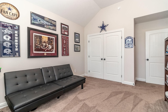 sitting room with vaulted ceiling and carpet