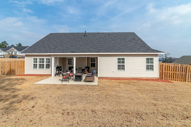 back of house with a yard, a fire pit, and a patio area