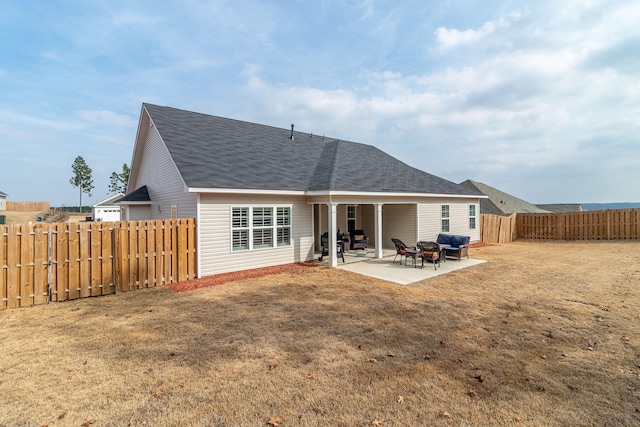 rear view of property with a lawn and a patio