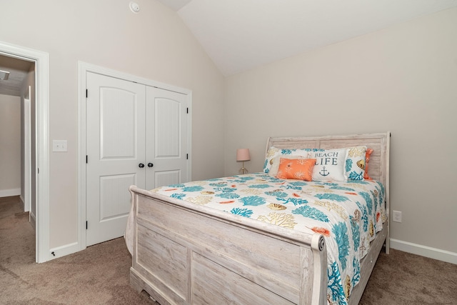 carpeted bedroom with lofted ceiling and a closet