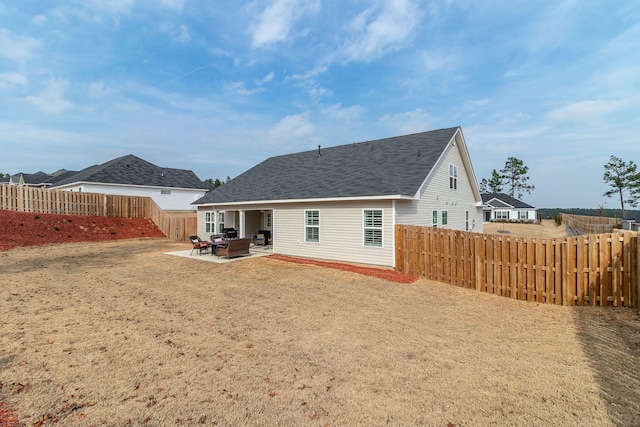 rear view of property featuring a patio area and a lawn