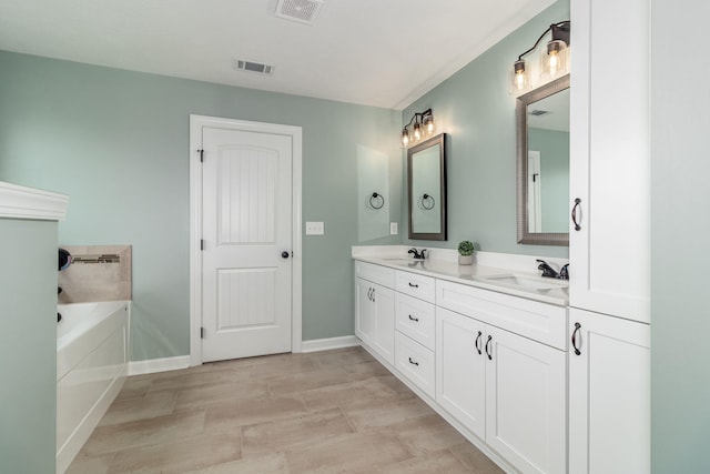 bathroom featuring vanity and a washtub