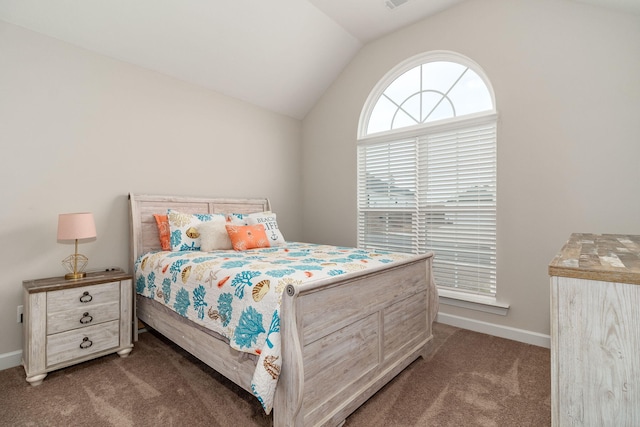 bedroom with vaulted ceiling and dark colored carpet