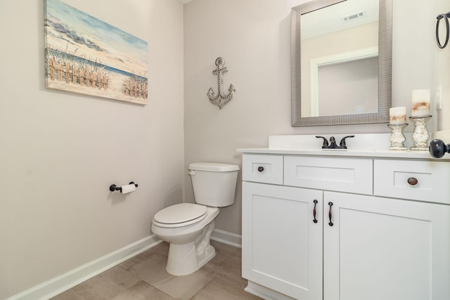 bathroom featuring tile patterned flooring, vanity, and toilet