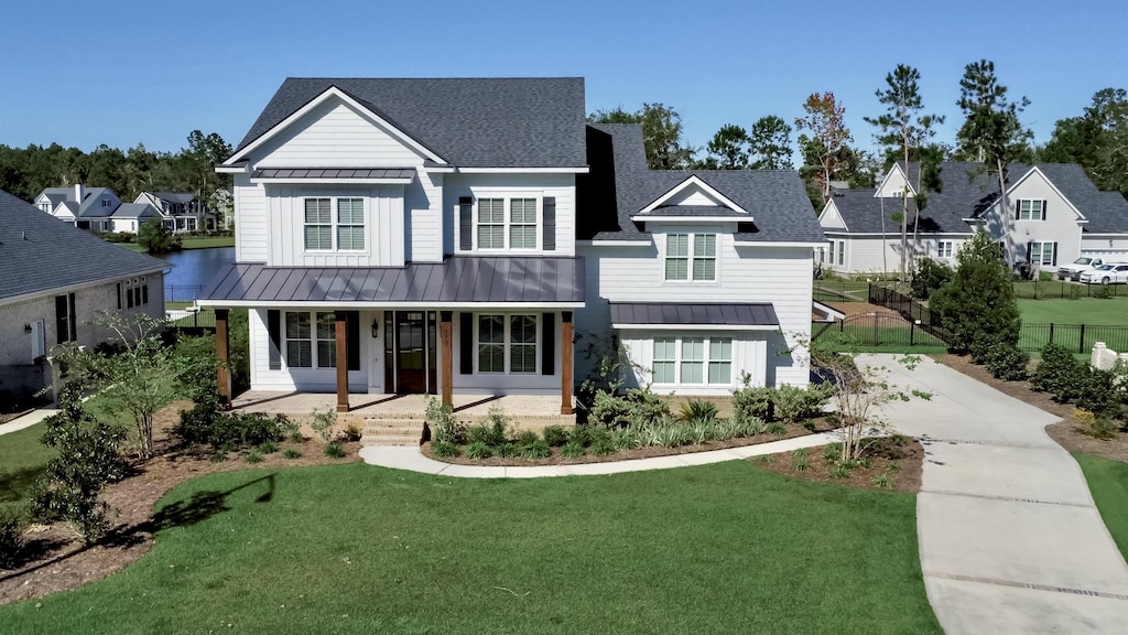 view of front of house featuring covered porch and a front lawn