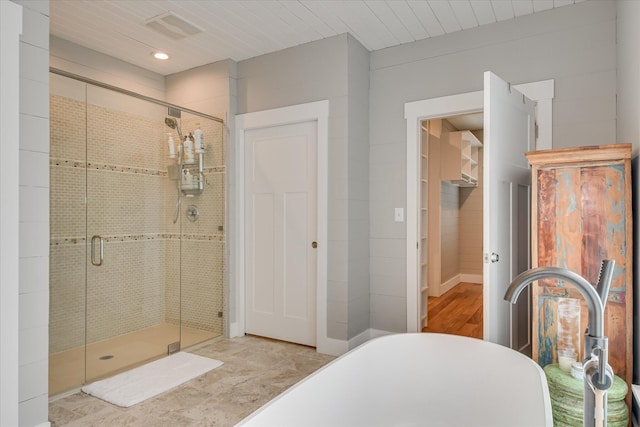 full bathroom with wood finished floors, recessed lighting, a freestanding bath, and a shower stall