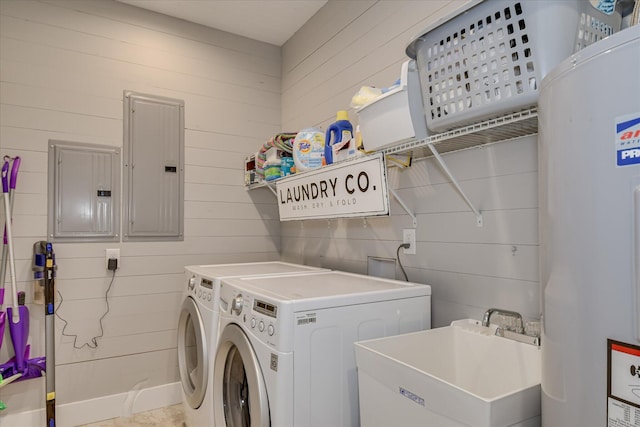 washroom with laundry area, a sink, electric panel, and separate washer and dryer