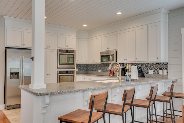 kitchen featuring a sink, white cabinetry, and stainless steel appliances