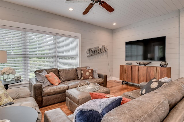 living room with wooden walls, recessed lighting, ceiling fan, and wood finished floors