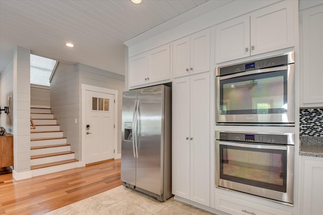 kitchen featuring white cabinets, recessed lighting, appliances with stainless steel finishes, and decorative backsplash