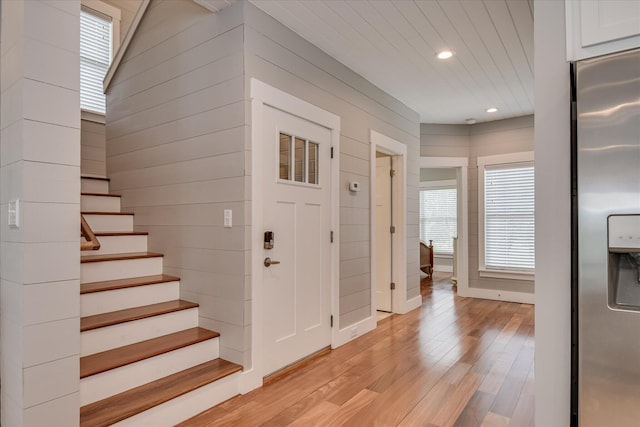 entryway with stairway, plenty of natural light, recessed lighting, and light wood-style flooring