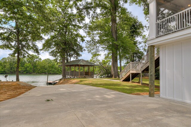 view of patio / terrace featuring a gazebo, a water view, and stairs