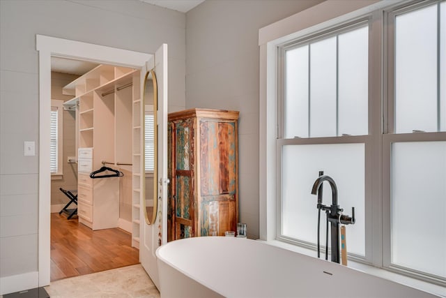bathroom with a soaking tub