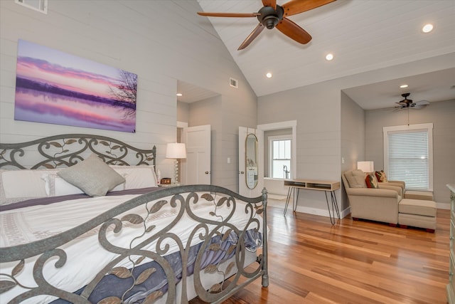 bedroom featuring visible vents, recessed lighting, wood finished floors, and high vaulted ceiling