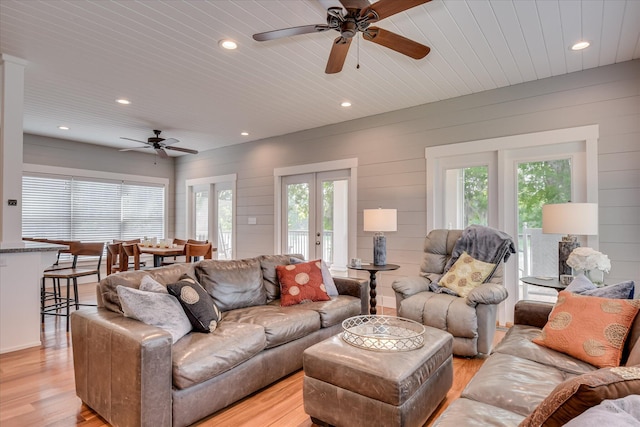 living room with a ceiling fan, recessed lighting, wooden ceiling, and light wood finished floors