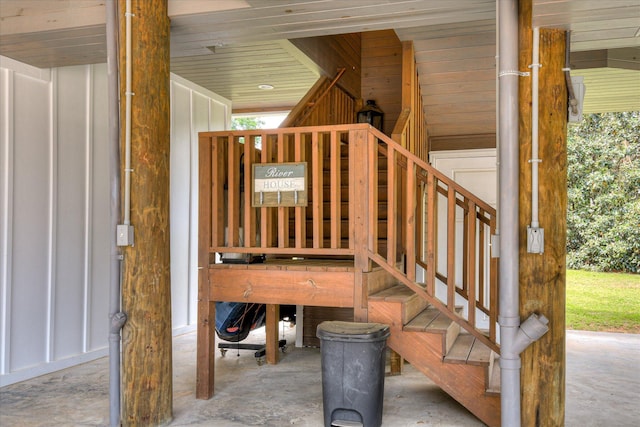 staircase with plenty of natural light and concrete flooring