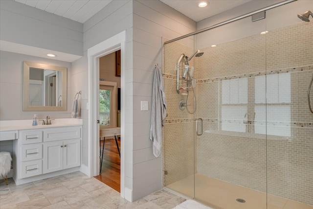 full bath featuring vanity, a shower stall, and recessed lighting