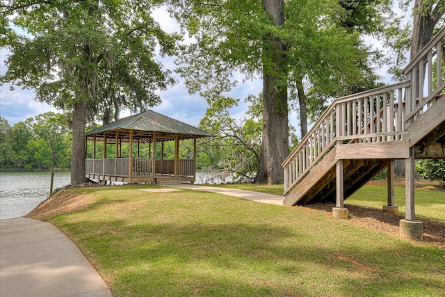 view of yard with a water view, a gazebo, and stairway