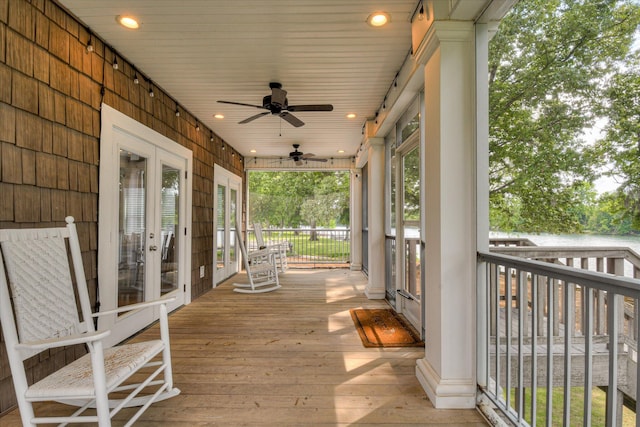 wooden terrace with ceiling fan and french doors