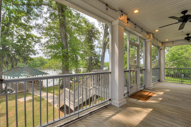 deck with a lawn and ceiling fan