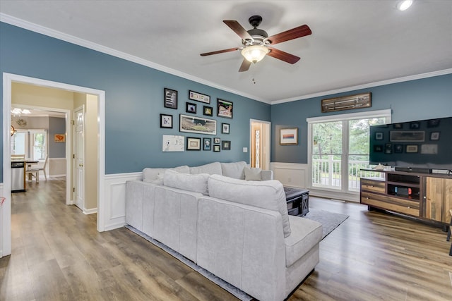 32 Creekside Dr, Aiken, SC 29803 - living room featuring ceiling fan, ornamental molding, plenty of natural light, wainscoting, and wood finished floors