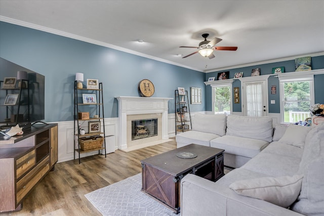 32 Creekside Dr, Aiken, SC 29803 - living area with wood finished floors, a ceiling fan, crown molding, a high end fireplace, and wainscoting