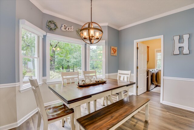 32 Creekside Dr, Aiken, SC 29803 - dining space with separate washer and dryer, a chandelier, plenty of natural light, and ornamental molding