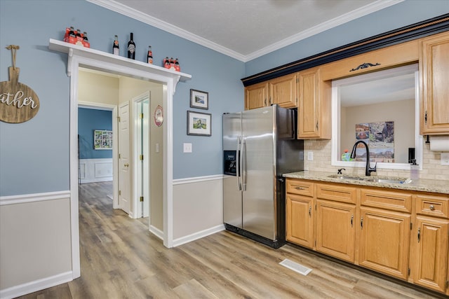 32 Creekside Dr, Aiken, SC 29803 - kitchen with a sink, stainless steel fridge, light wood-style flooring, tasteful backsplash, and ornamental molding
