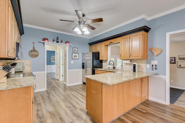 32 Creekside Dr, Aiken, SC 29803 - kitchen with stainless steel appliances, light wood finished floors, backsplash, a sink, and ornamental molding