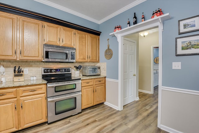 32 Creekside Dr, Aiken, SC 29803 - kitchen with stainless steel appliances, tasteful backsplash, light wood-type flooring, light stone countertops, and ornamental molding