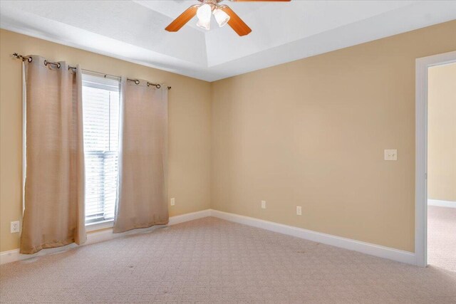 empty room featuring carpet flooring, ceiling fan, and plenty of natural light