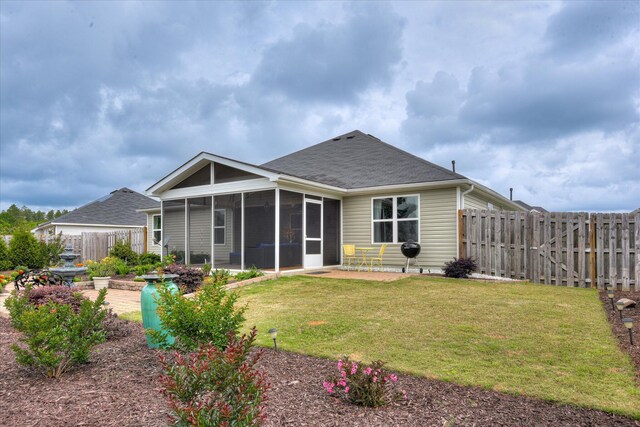 4932 Fairmont Dr, Graniteville, SC 29829 - back of property with a shingled roof, a sunroom, a fenced backyard, a patio area, and a yard