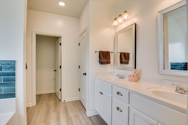 4932 Fairmont Dr, Graniteville, SC 29829 - full bath with double vanity, a sink, and wood finished floors