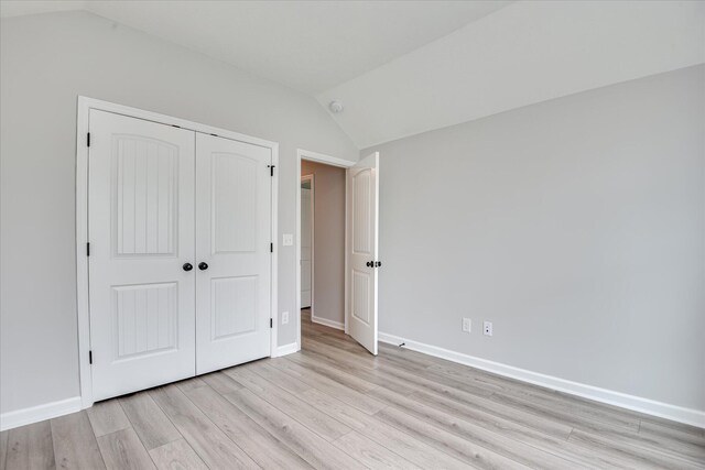4932 Fairmont Dr, Graniteville, SC 29829 - unfurnished bedroom with light wood-style floors, baseboards, vaulted ceiling, and a closet