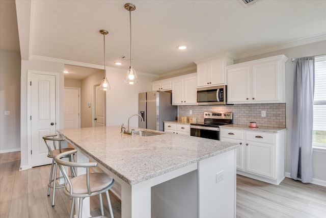 4932 Fairmont Dr, Graniteville, SC 29829 - kitchen featuring an island with sink, a sink, white cabinetry, and appliances with stainless steel finishes