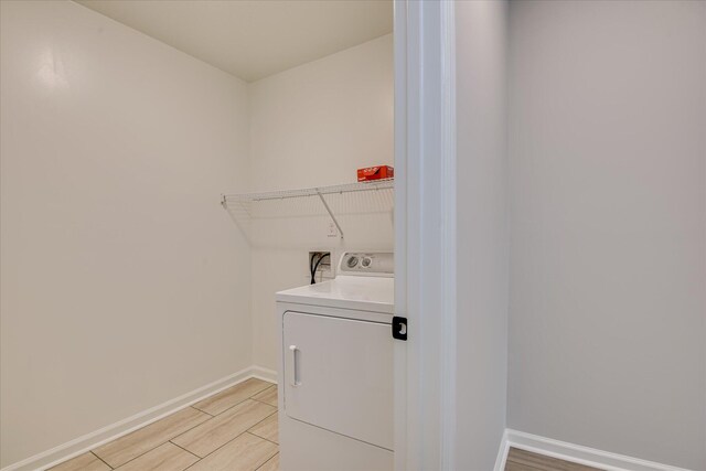 4932 Fairmont Dr, Graniteville, SC 29829 - laundry room featuring washer / dryer, baseboards, laundry area, and light wood-style flooring