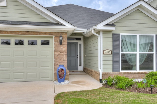 4932 Fairmont Dr, Graniteville, SC 29829 - doorway to property with a shingled roof, an attached garage, and driveway