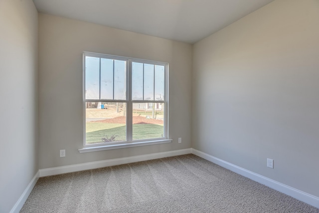 spare room with carpet floors and baseboards