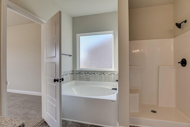 bathroom featuring walk in shower and a bath