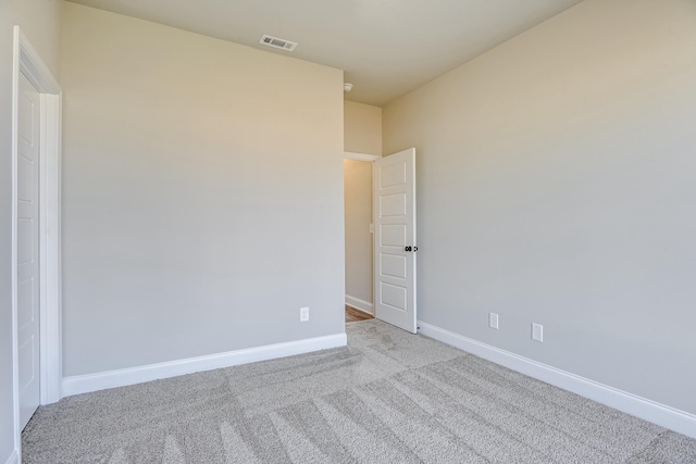 unfurnished room featuring carpet floors, baseboards, and visible vents