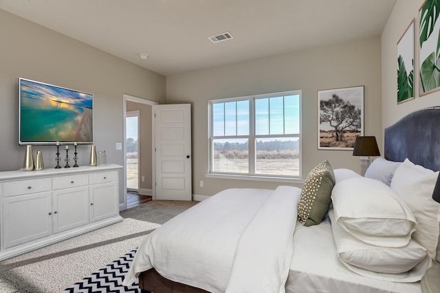 bedroom featuring visible vents and baseboards