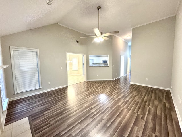 unfurnished living room with dark hardwood / wood-style flooring, a textured ceiling, ceiling fan, crown molding, and high vaulted ceiling