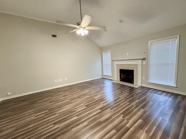 unfurnished living room with ceiling fan, dark hardwood / wood-style flooring, a fireplace, and vaulted ceiling