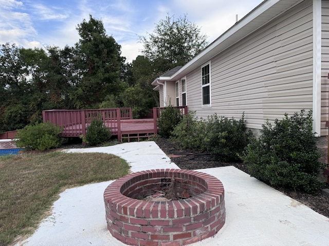 view of patio with a fire pit and a deck