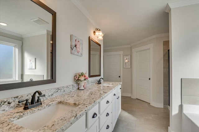 bathroom featuring ornamental molding, vanity, and a tub