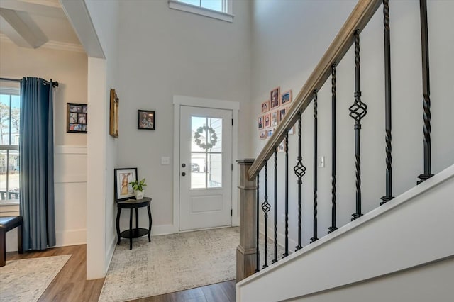 foyer with light hardwood / wood-style flooring and a high ceiling