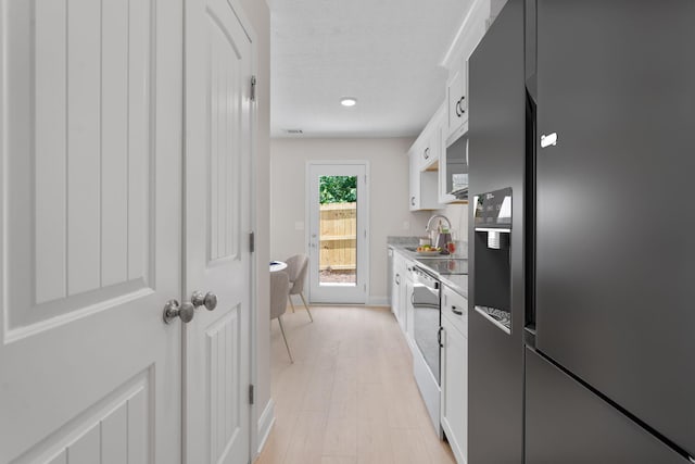 2247 Archer Ln, Augusta, GA 30906 - kitchen featuring stainless steel fridge, white cabinets, light wood-style flooring, and recessed lighting