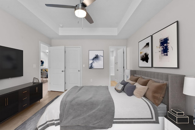 2247 Archer Ln, Augusta, GA 30906 - bedroom featuring a raised ceiling, wood finished floors, connected bathroom, and a ceiling fan